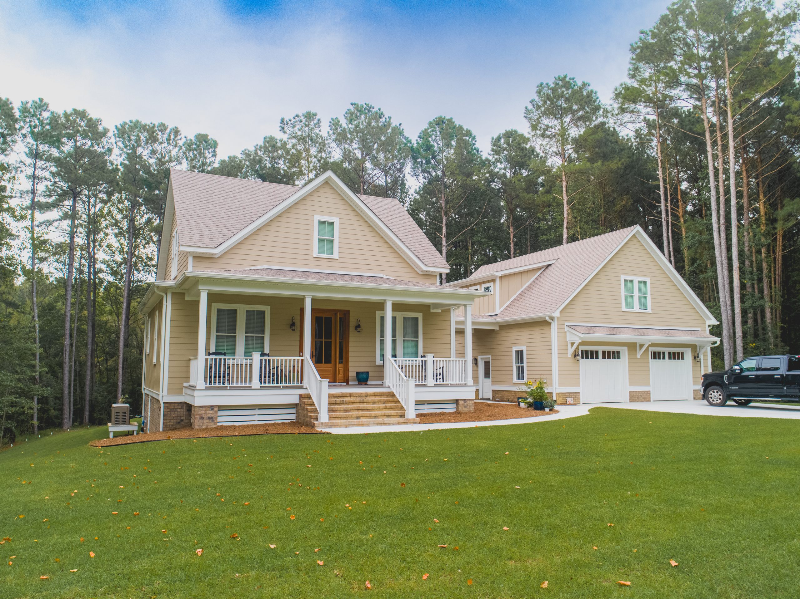 exterior view of tan house with detached garage