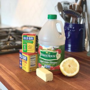 Ingredients for making a seafood sauce on a butcher block counter top.