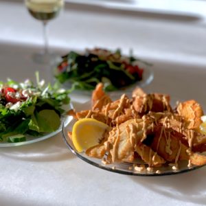 Fresh food on a table with white table cloth.