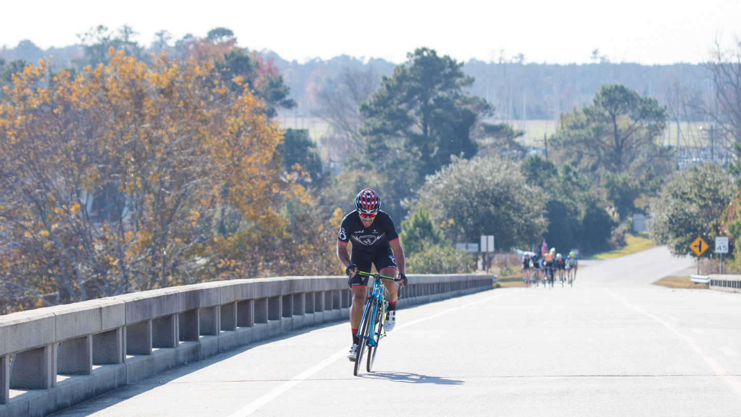Bike rider heading up the Oriental bridge.